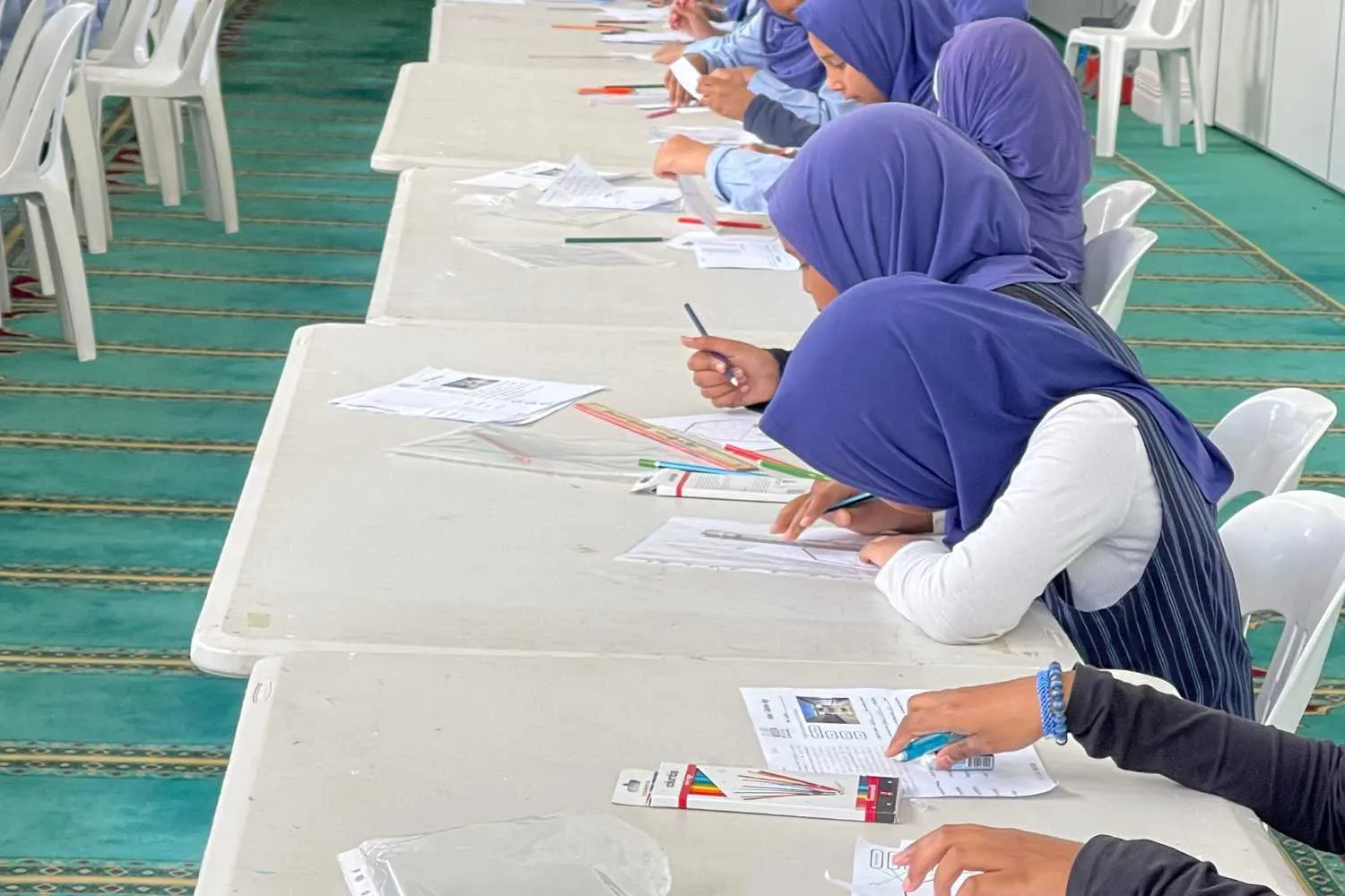 Students working on activity sheets during an incursion