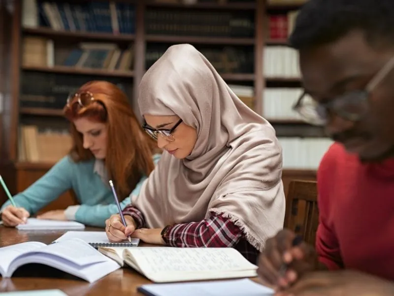 Students studying together in a library